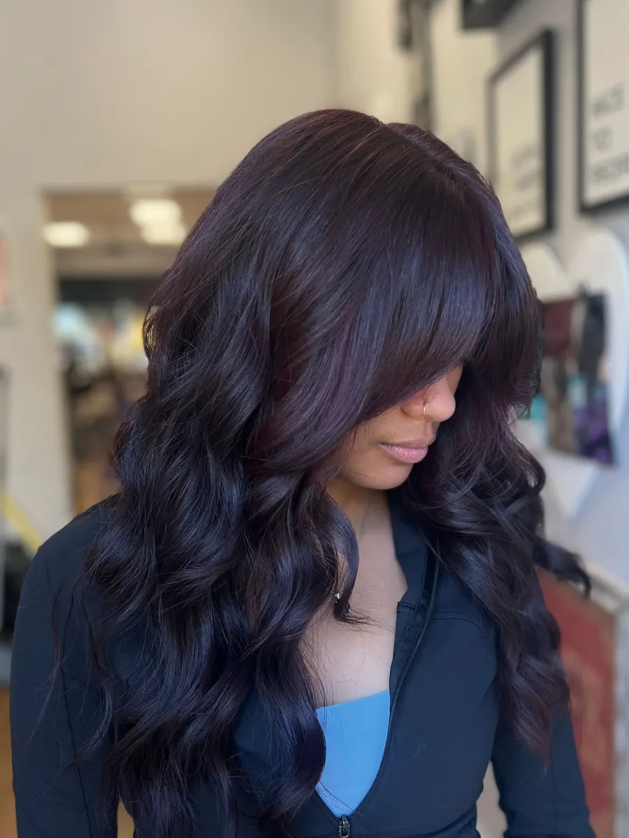 Long dark waves with soft bangs finished at Hair House