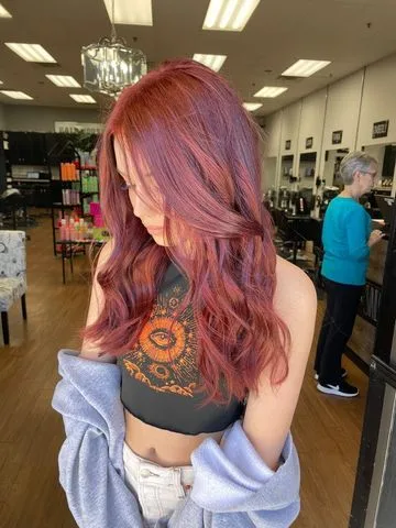 Long wavy red color styled in soft curls