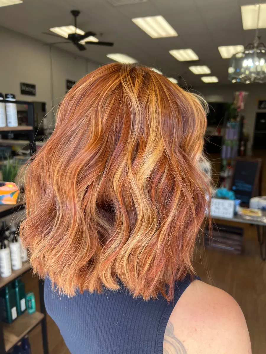 Shoulder-length copper hair with bright dimension